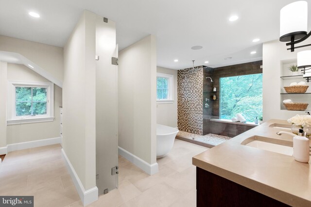 full bath with recessed lighting, a sink, a freestanding bath, and a walk in shower