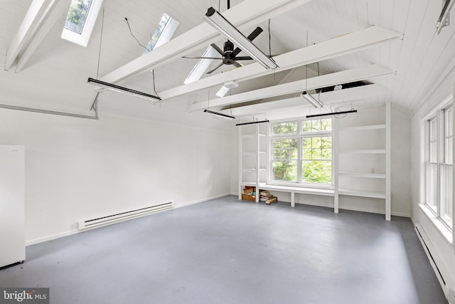 garage featuring ceiling fan, baseboard heating, a baseboard radiator, and freestanding refrigerator