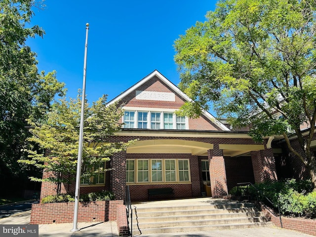 view of front facade with a porch and brick siding