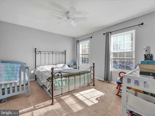 bedroom featuring ceiling fan and light carpet