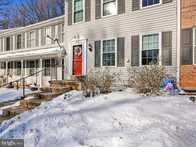 view of snow covered property entrance