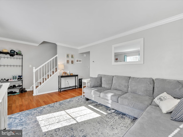 living room with wood-type flooring and ornamental molding