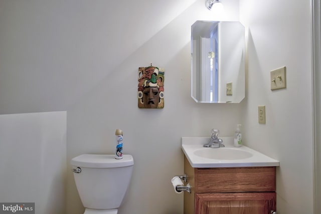 half bathroom featuring toilet and vanity