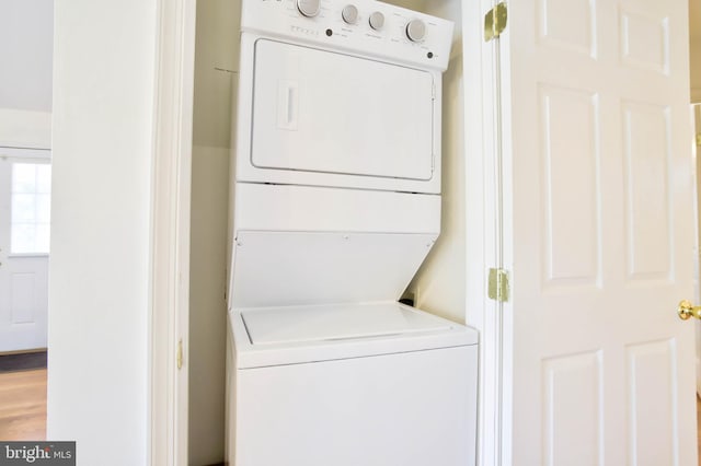 laundry area with laundry area and stacked washer / drying machine