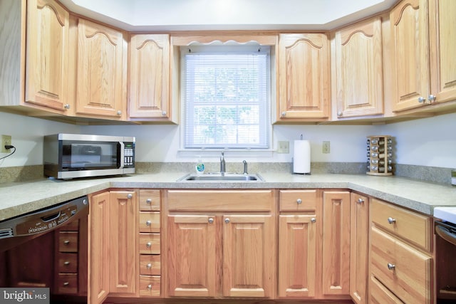 kitchen with dishwasher, stainless steel microwave, light brown cabinets, and a sink