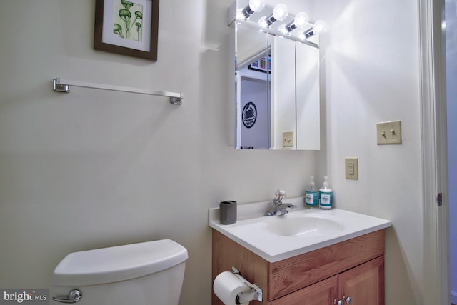 half bathroom featuring toilet and vanity