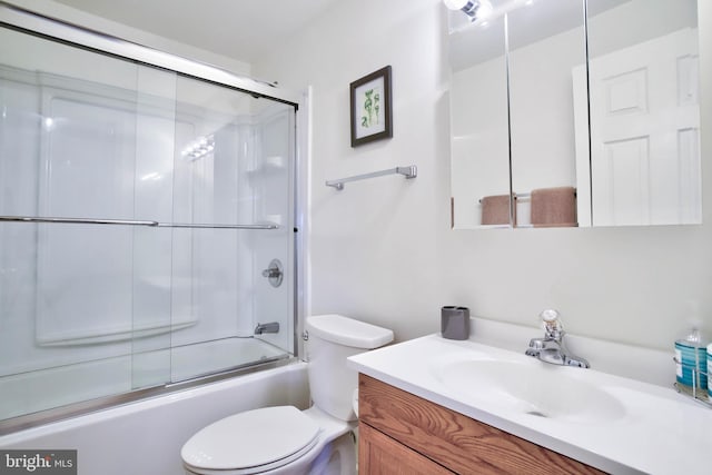 bathroom with enclosed tub / shower combo, toilet, and vanity