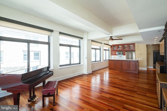 living room with ceiling fan, dark hardwood / wood-style floors, and sink