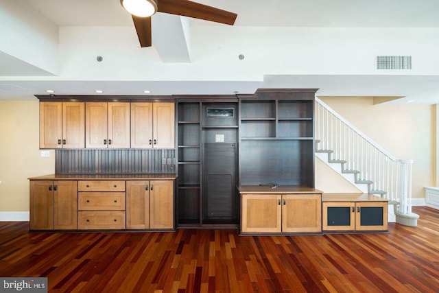 kitchen featuring ceiling fan, a high ceiling, and dark hardwood / wood-style floors