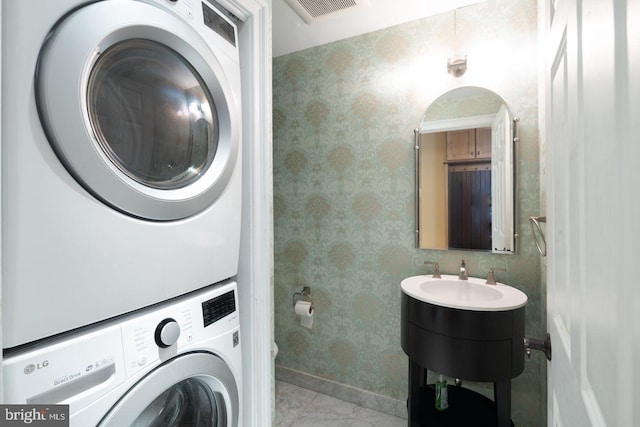 laundry area with stacked washer and dryer