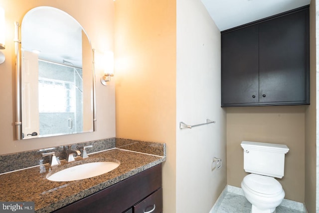 bathroom featuring toilet and vanity