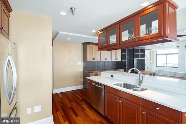 kitchen featuring dark wood-type flooring, appliances with stainless steel finishes, backsplash, and sink