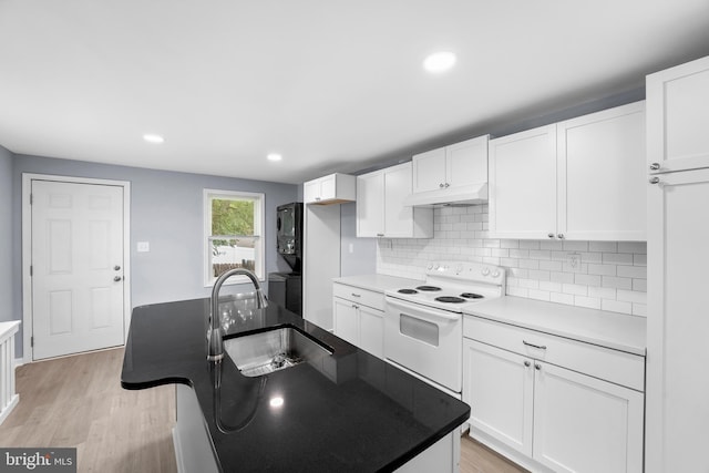 kitchen with white cabinets, light hardwood / wood-style floors, sink, electric stove, and tasteful backsplash