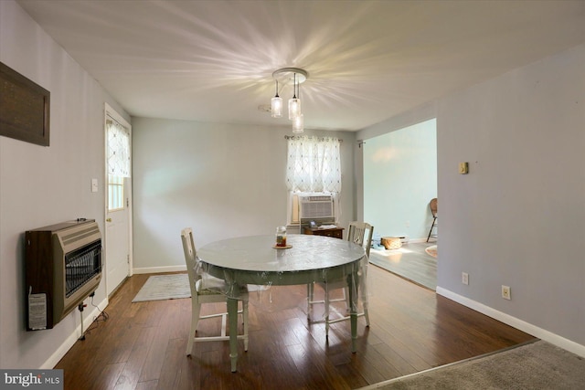 dining room featuring heating unit, cooling unit, and dark hardwood / wood-style floors