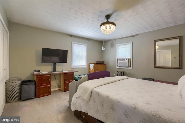 carpeted bedroom featuring cooling unit and a closet