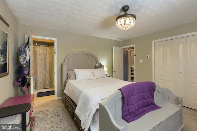 carpeted bedroom featuring a textured ceiling and a closet