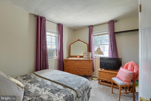 carpeted bedroom featuring a textured ceiling and cooling unit