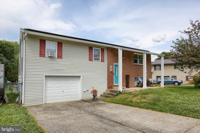 bi-level home featuring a front lawn, driveway, entry steps, cooling unit, and a garage