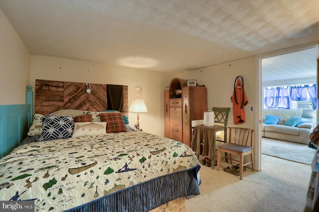 bedroom with carpet flooring and a textured ceiling