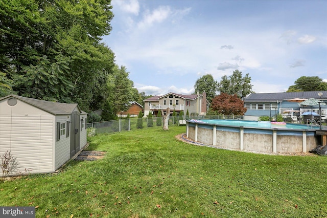 view of yard with a storage unit and a fenced in pool