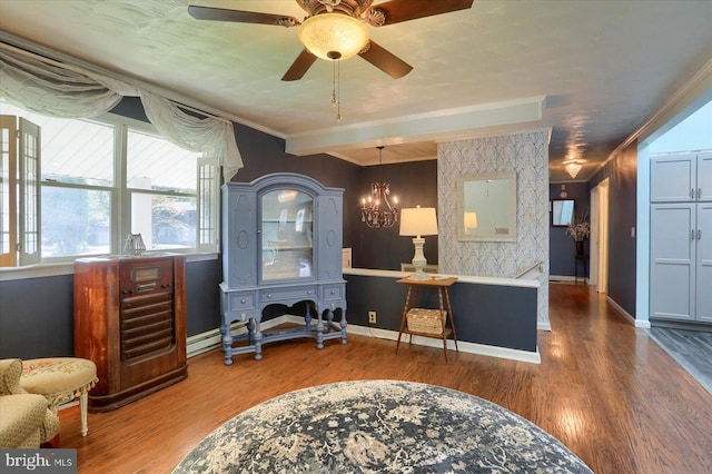 home office with ornamental molding, ceiling fan with notable chandelier, and hardwood / wood-style flooring