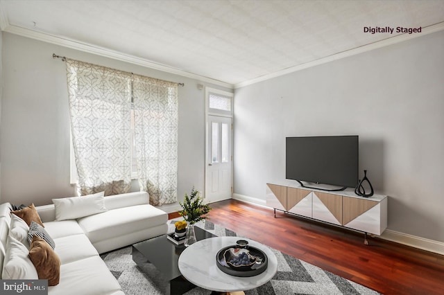 living room with crown molding, baseboards, and wood finished floors