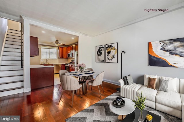 living room with ceiling fan, dark hardwood / wood-style floors, and sink