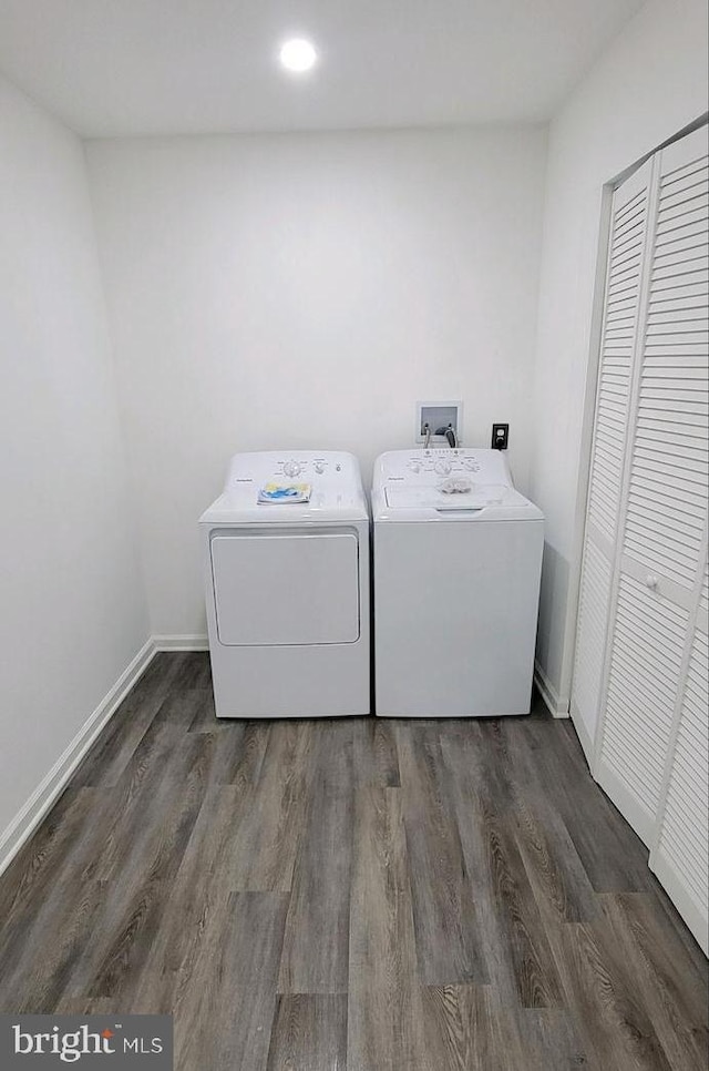 clothes washing area featuring separate washer and dryer and dark wood-type flooring