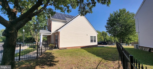 view of side of home with a lawn