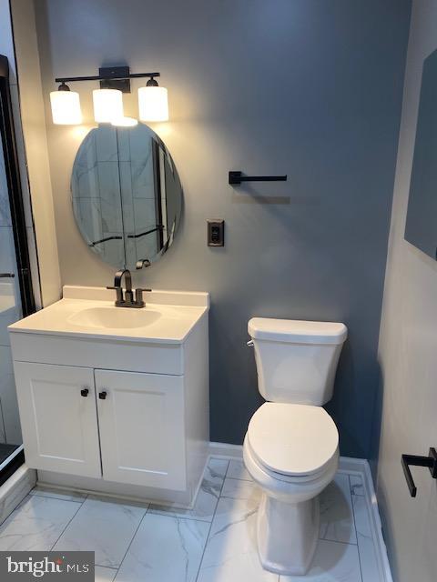 bathroom featuring vanity and toilet