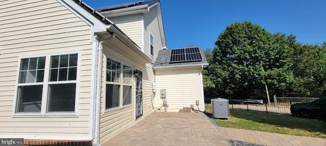 view of side of home featuring solar panels and a patio area