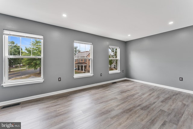 empty room with light hardwood / wood-style flooring