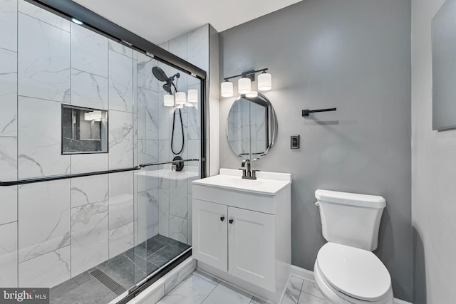 bathroom featuring an enclosed shower, vanity, and toilet