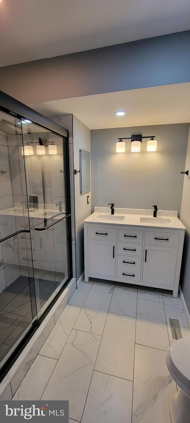 bathroom featuring walk in shower, vanity, and toilet