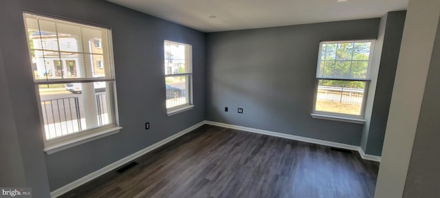 spare room featuring dark wood-type flooring