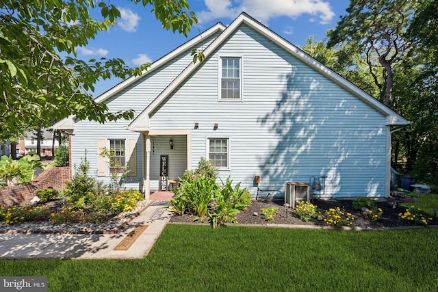 rear view of property featuring a yard