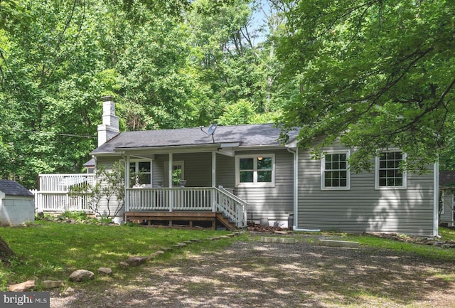 back of house with a lawn