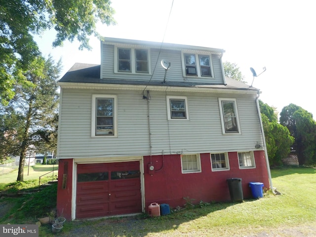 view of side of property with a garage and a yard