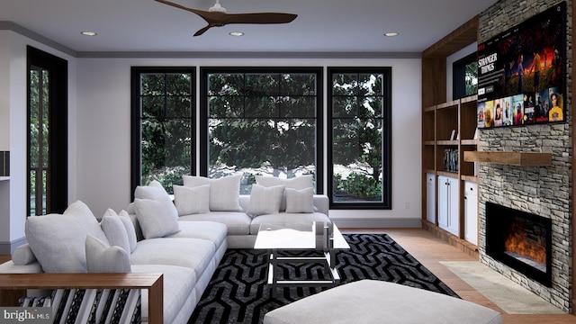 living room with crown molding, plenty of natural light, and a fireplace