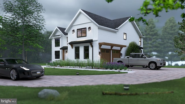 modern farmhouse with driveway, a garage, board and batten siding, and a front yard