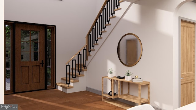 entryway featuring stairway and wood finished floors