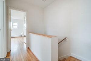 corridor with light hardwood / wood-style floors