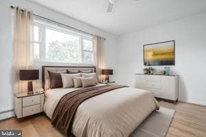 bedroom featuring ceiling fan and light hardwood / wood-style flooring