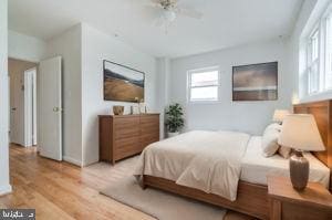 bedroom with ceiling fan and light hardwood / wood-style floors