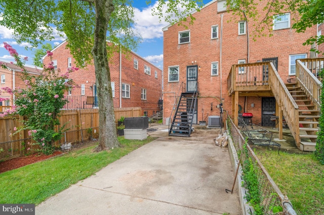 back of house with a patio area, a wooden deck, and central AC unit