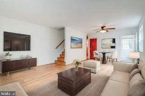 living room with ceiling fan and light hardwood / wood-style floors