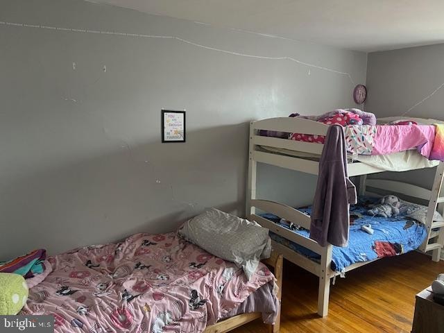 bedroom with wood-type flooring