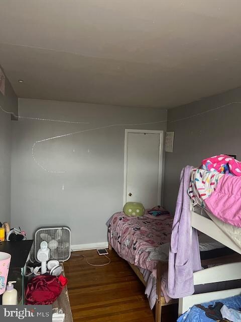 bedroom with dark wood-type flooring