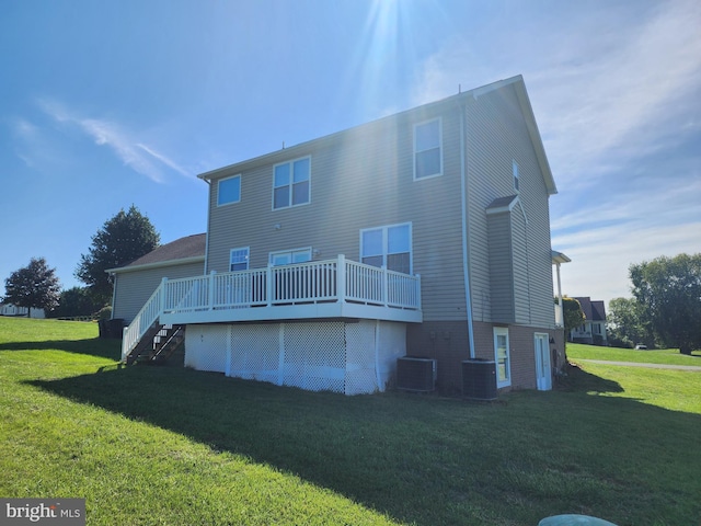 rear view of property with central AC, a lawn, stairway, and a wooden deck