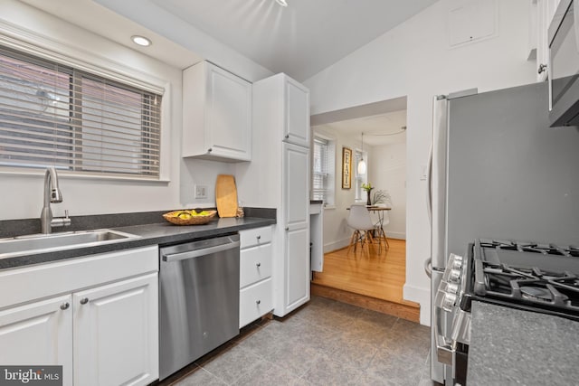 kitchen featuring light wood-type flooring, white cabinets, stainless steel appliances, and sink